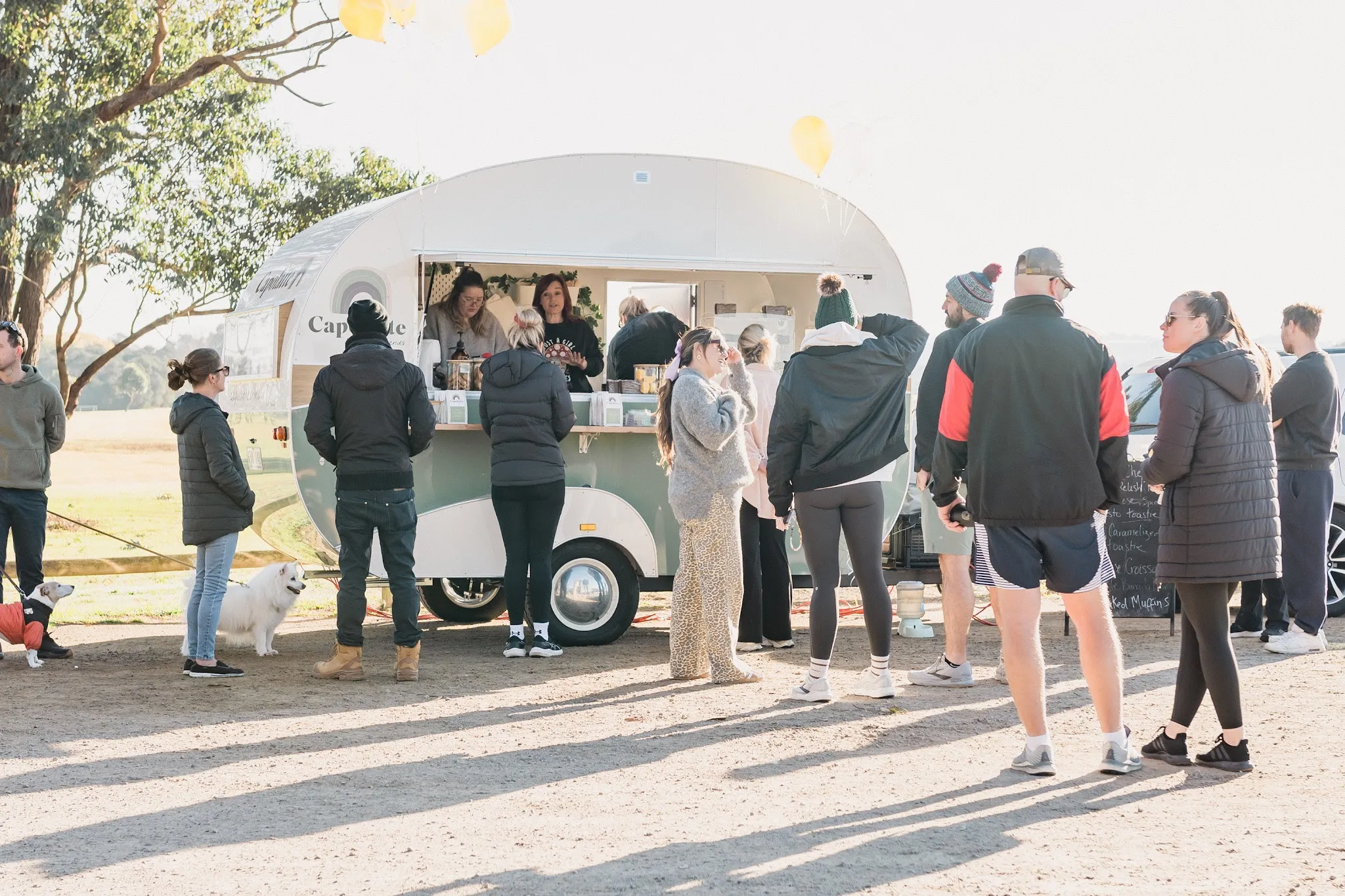Capolatte caravan with a queue of about 15 customers on a bright winter morning