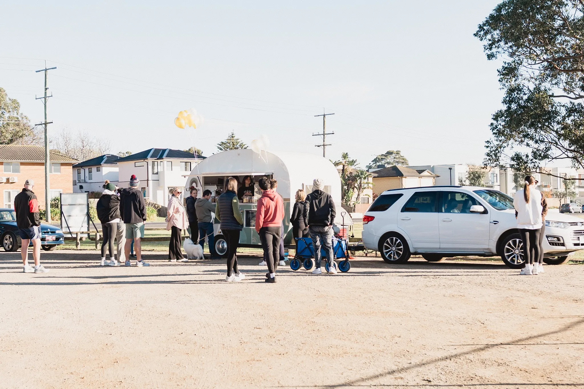 Capolatte caravan with a crowd of customers queuing at the foreshore